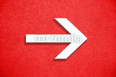 Red White Arrow Logo - White arrow direction sign over vivid bright red color stucco rough