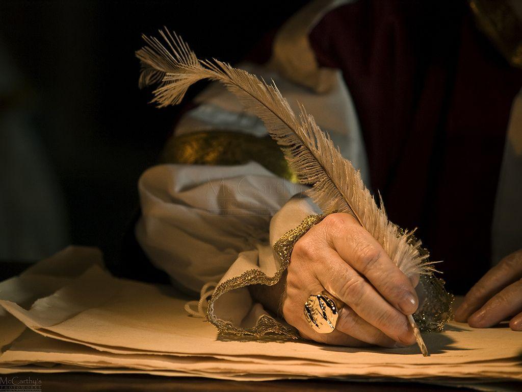 Quill in Hand Logo - Quill and Signet Ring. A senior man's hand holding a quill