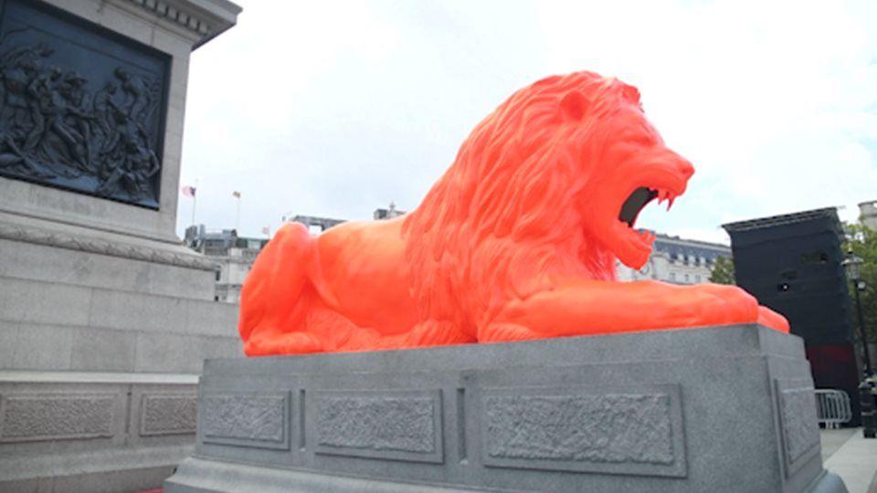 A Reddish Orange Lion Logo - A fifth lion statue is unveiled at Trafalgar Square | London Live