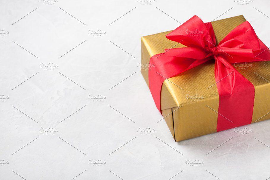 White Box with a Red a Logo - Golden gift box tied with a red ribbon isolated on white background ...