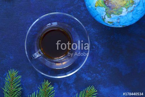 Branches with Blue and Blue Globe Logo - Cup of black coffee, globe, fir-tree branches, on a blue background ...