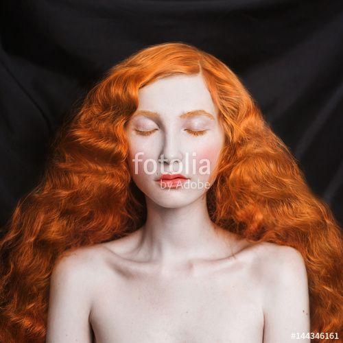 Red Lady with Flowing Hair Logo - Woman with long curly red flowing hair on a black background. Red