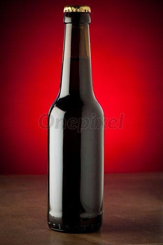 Beer with Red Background Logo - Bottle of beer on a stone table over red background