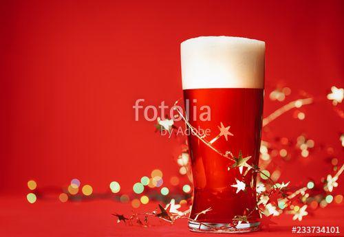 Beer with Red Background Logo - Pale ale or beer in pint glass with christmas lights and tinsel on ...
