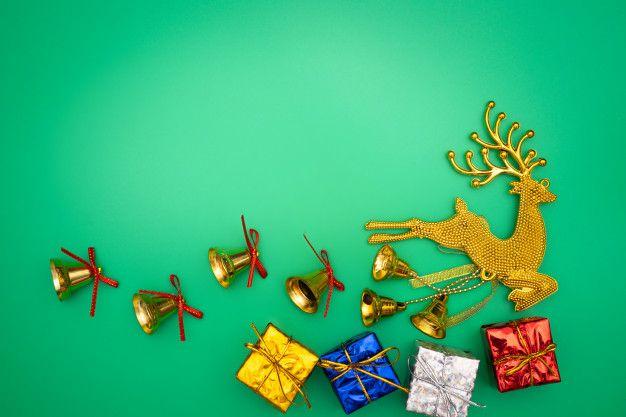 Green and Gold Reindeer Logo - Christmas gift, gold reindeer and bell on green background. Flat lay ...