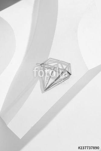Silver Diamond Shaped Logo - Close up top view of a shiny silver hairpin with openwork diamond ...
