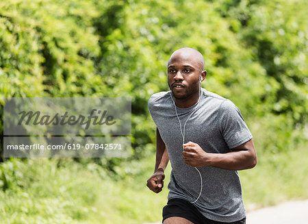Black Man Running Logo - Black man running in park - Stock Photo - Masterfile - Premium ...