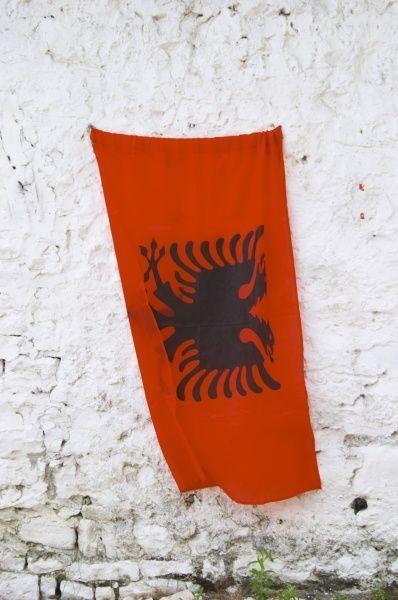 Red Double Headed Eagle Logo - The Albanian flag, red with black double headed eagle, against a ...