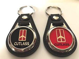 FOB Cross Logo - CUTLASS SUPREME KEYCHAIN 2 PACK OLDSMOBILE FOB LOGO RED AND BLACK