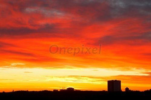 Sunrise Yellow and Red Logo - Bright red, yellow, blue clouds in sunrise sky